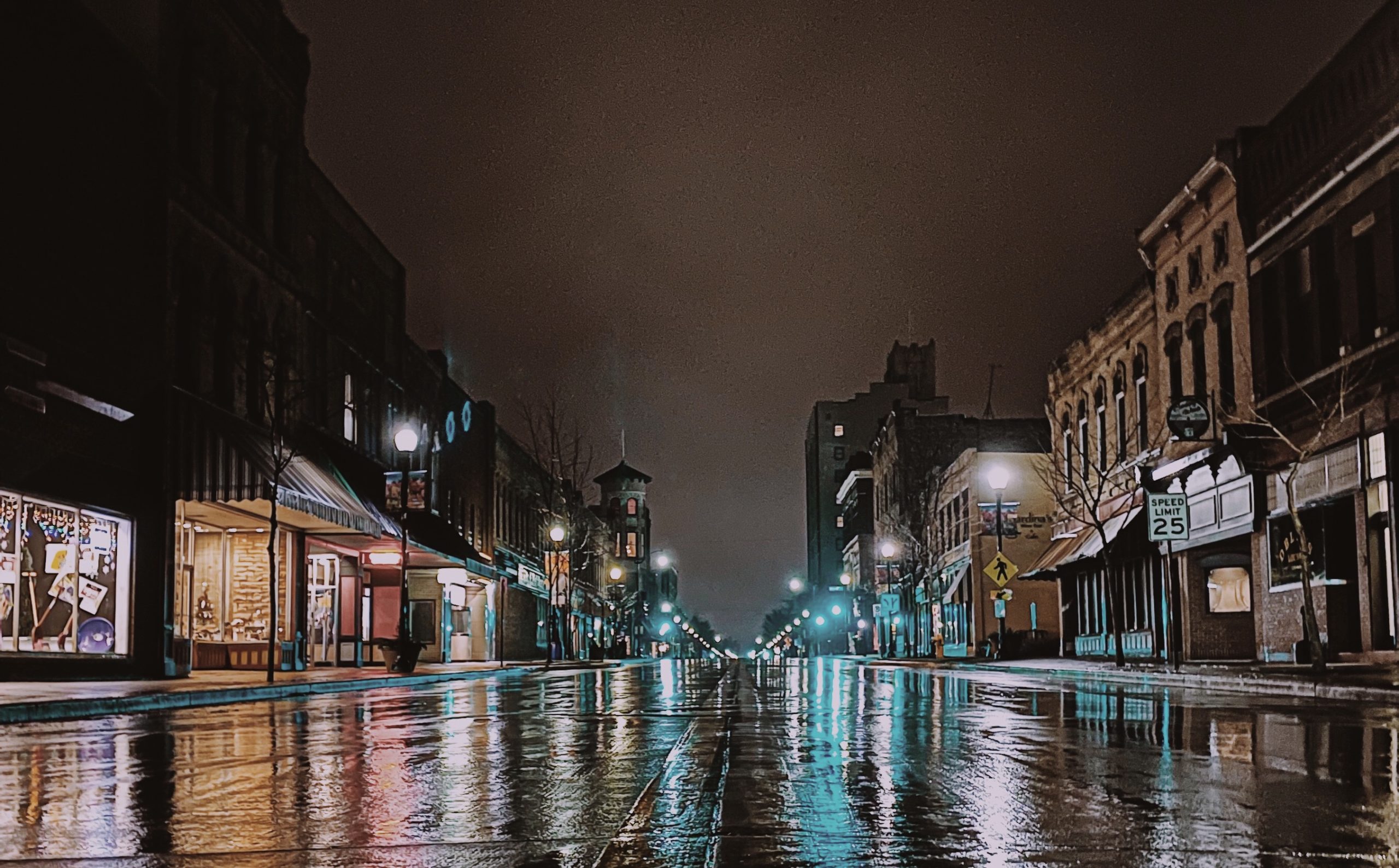 Downtown Oshkosh at night with reflections on wet streets